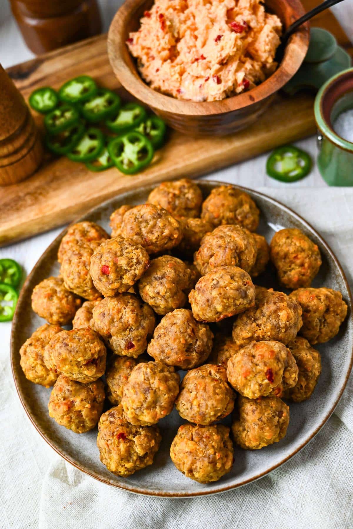 a platter of sausage balls with pimento cheese and jalapenos around it