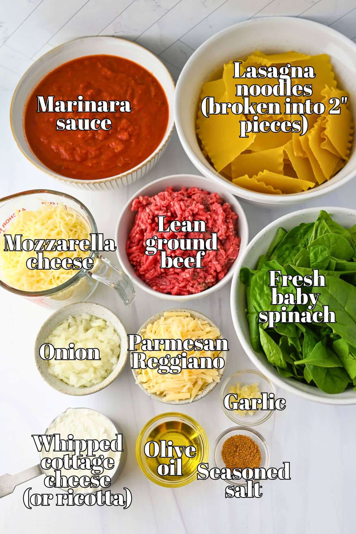 labeled ingredients for high protein sheet pan lasagna measured out on a counter