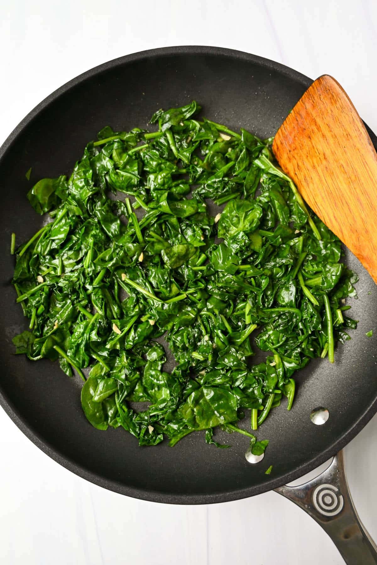 cooked spinach and garlic in a skillet