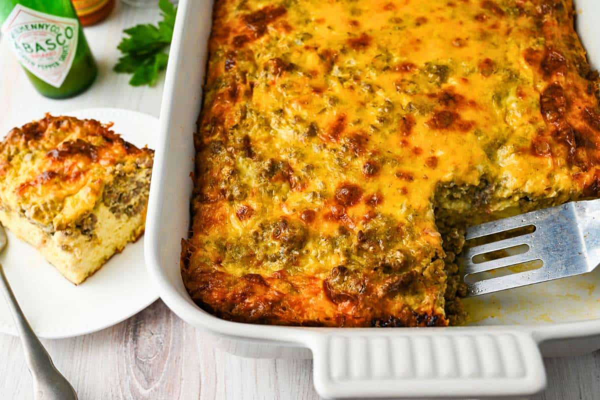 a pan of beef breakfast casserole with a plated slice next to it
