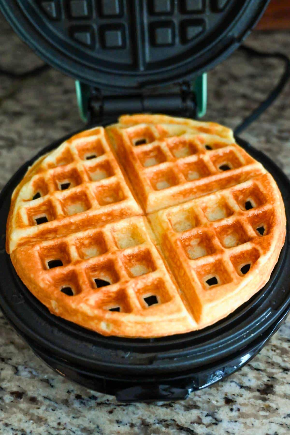 cooked waffle in a waffle iron