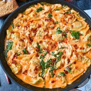 close up of a pan of curry dumpling bake with spinach and chicken