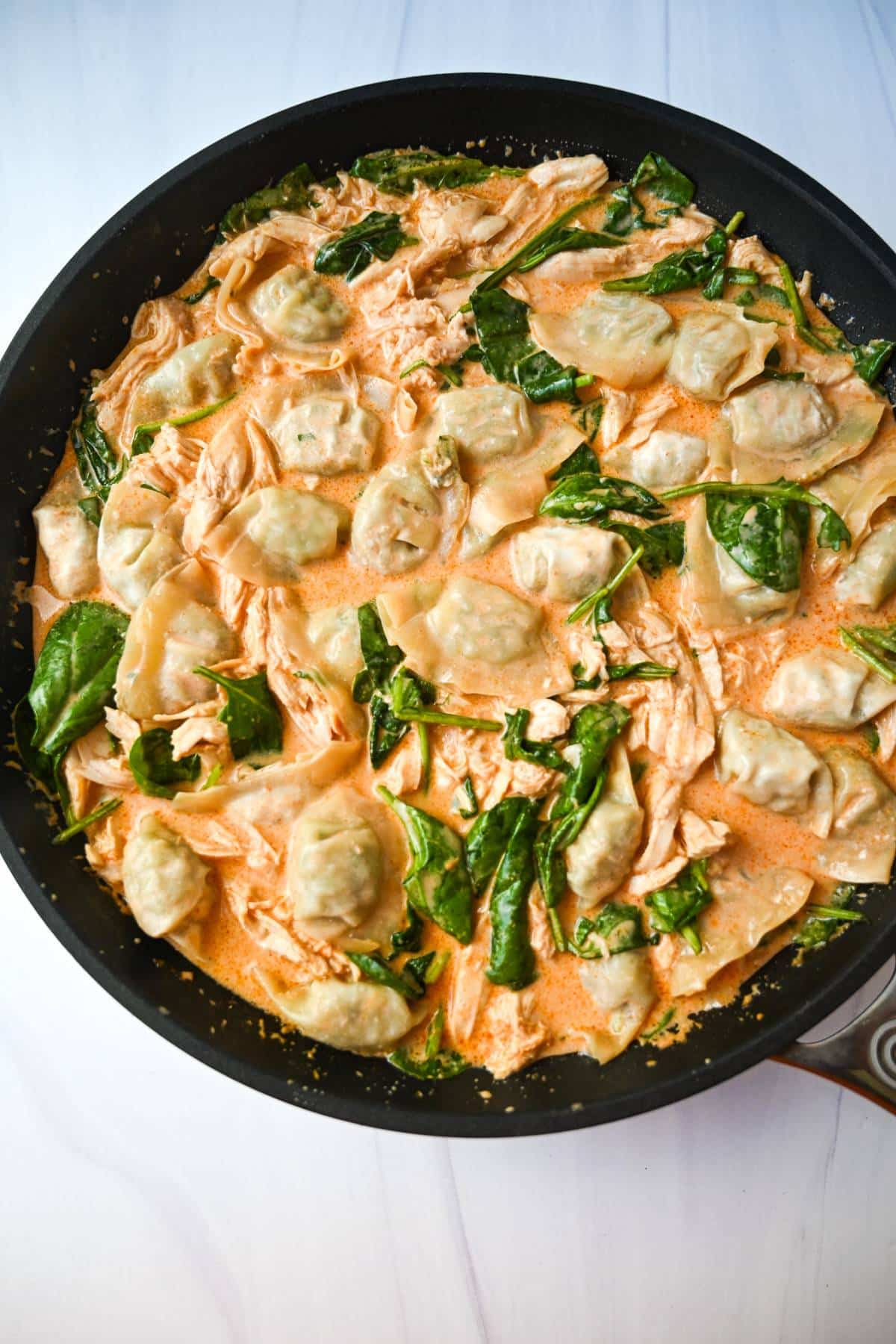 a pan of dumplings in curry sauce ready to cook