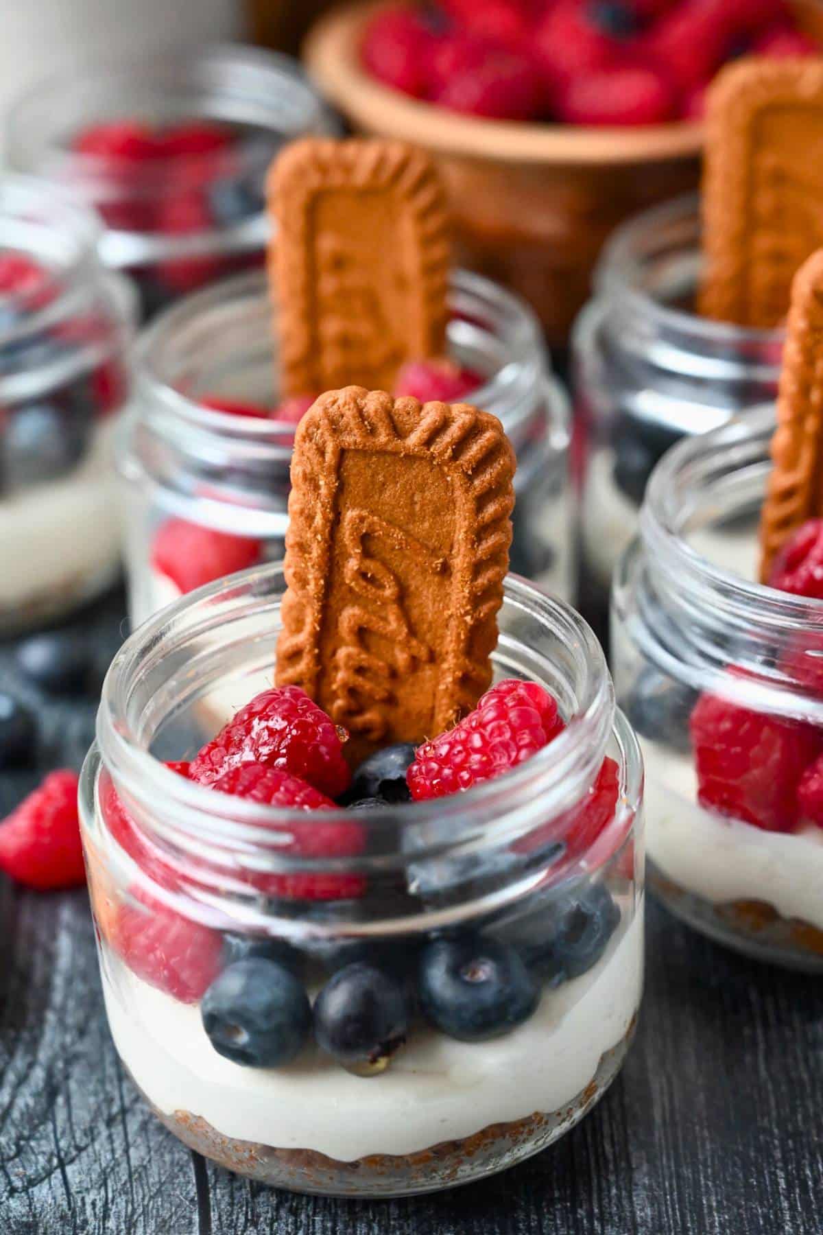 mini jar high protein no bake cheesecakes with berries and Biscoff cookies
