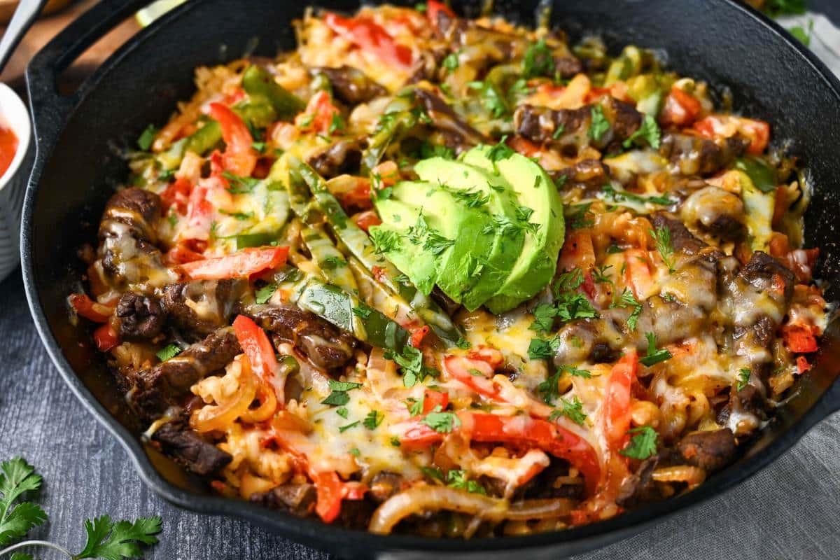close up of a fajita rice steak dinner in a skillet meal
