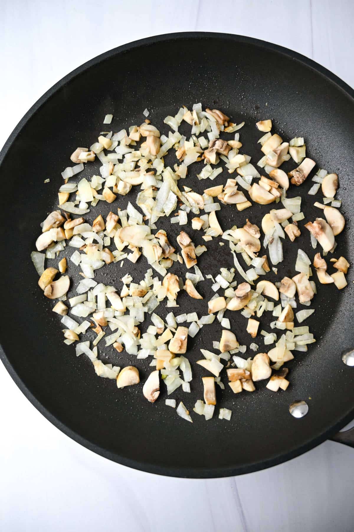 sauteed onions and mushrooms in a skillet