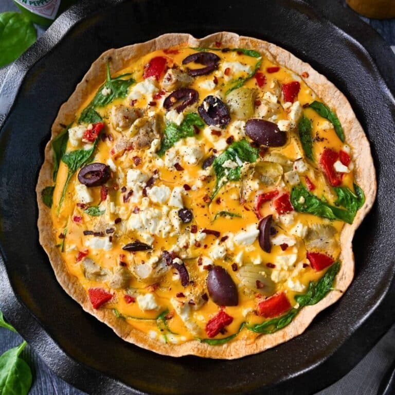 close up of a baked egg tortilla quiche with vegetables