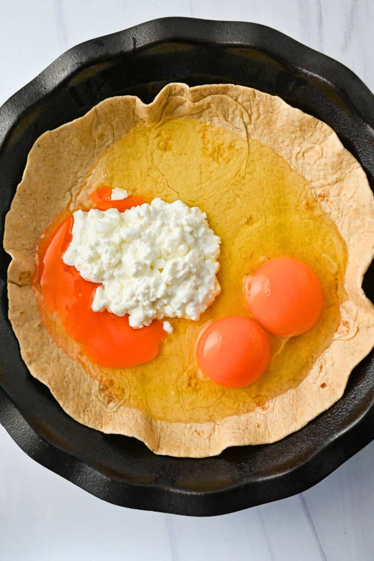 eggs and cottage cheese in a tortilla shell