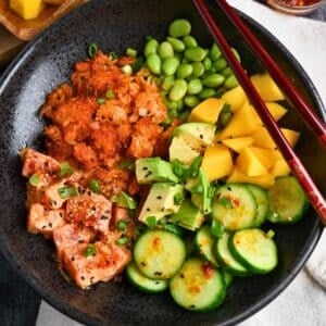 close up of a spicy tuna crispy rice salad bowl with dressing on top