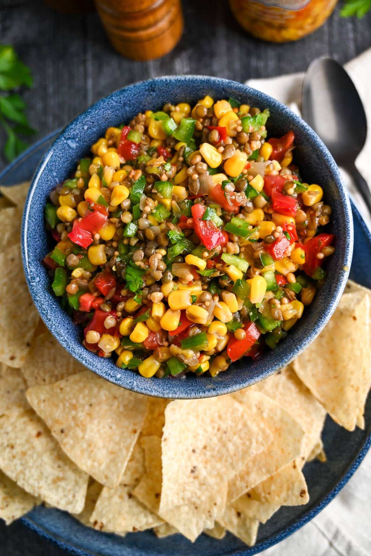looking down at a platter with chips and corn and bean salsa 