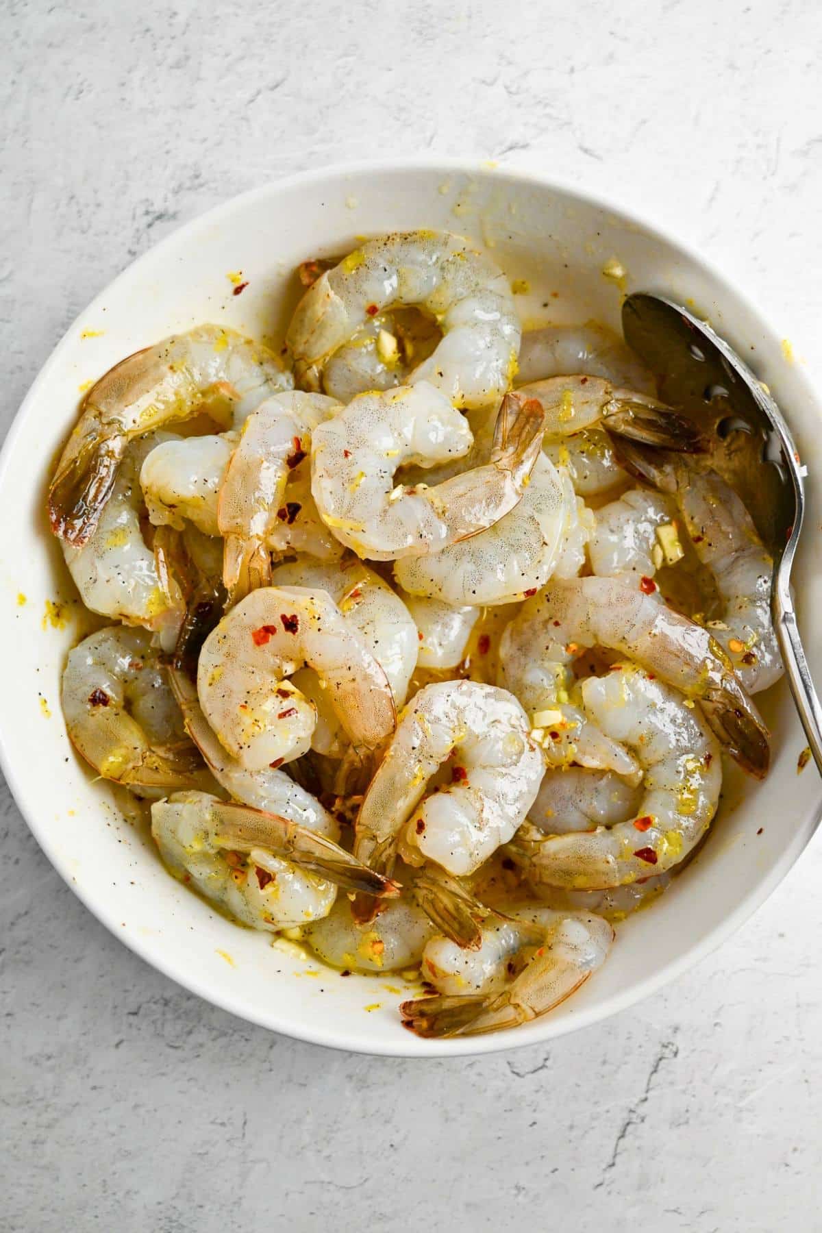 marinating shrimp in a bowl