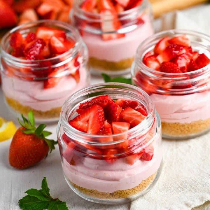 strawberry cheesecake parfaits with fresh chopped strawberries on top