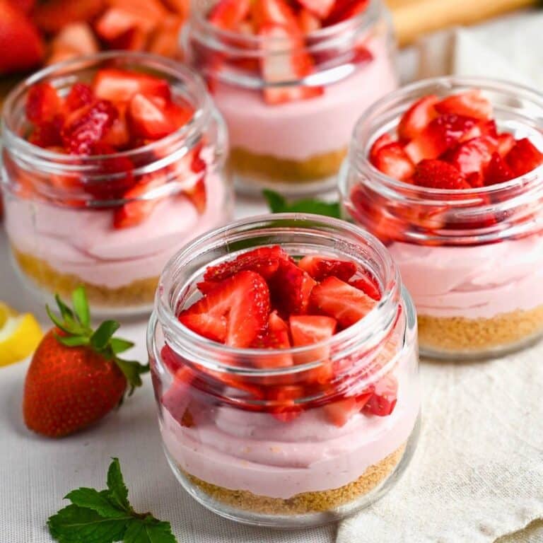 strawberry cheesecake parfaits with fresh chopped strawberries on top