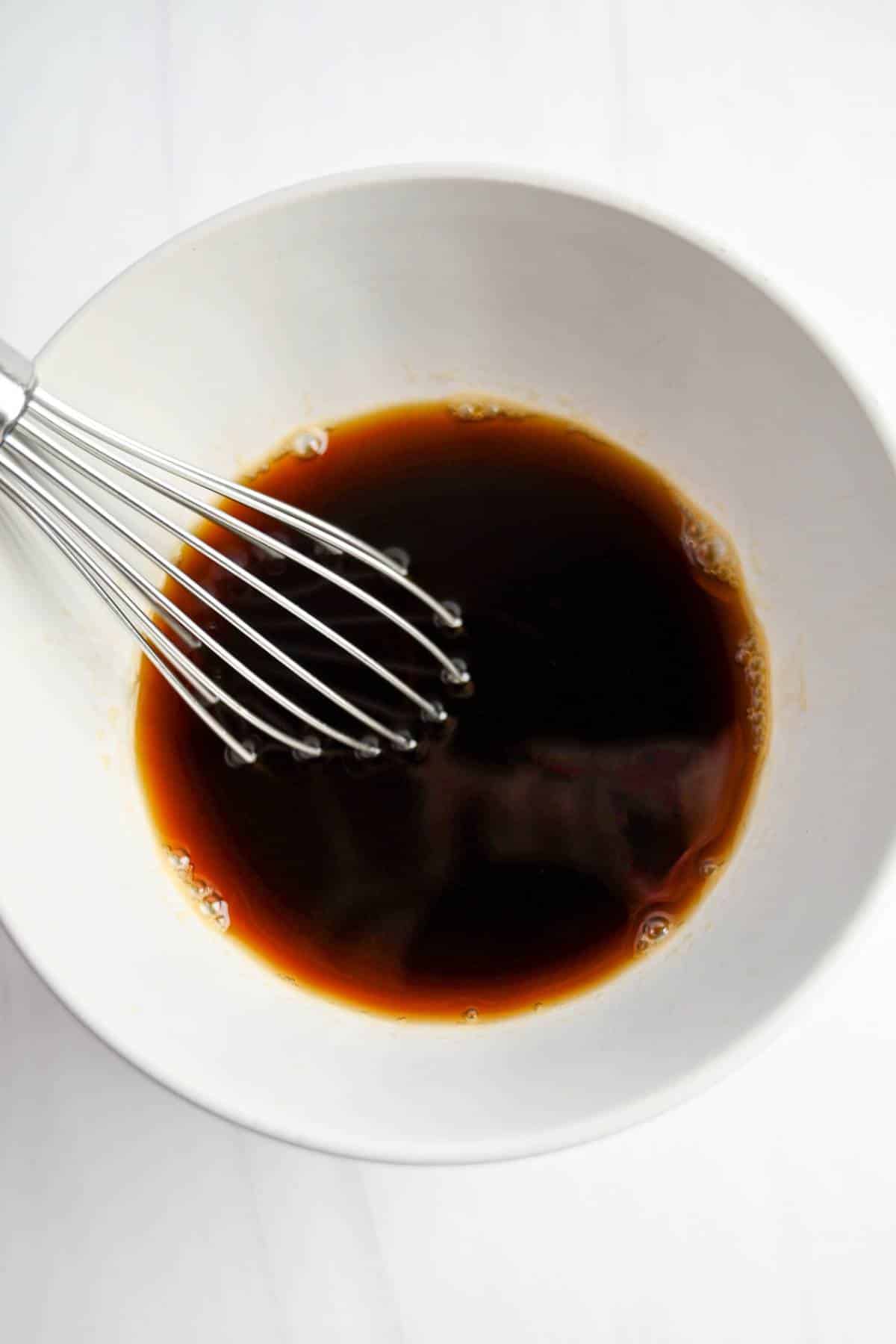 coffee mixture with a whisk in a bowl for tiramisu