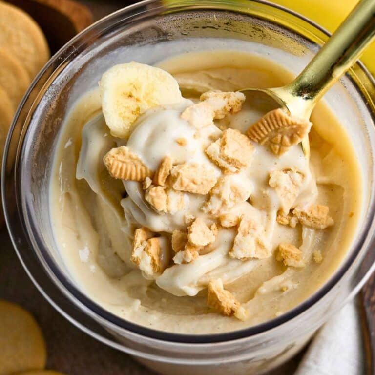 close up of a pint of high protein banana pudding creami ice cream with crushed cookies on top