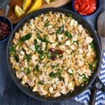a chicken orzo skillet with fresh dill and olives on top