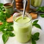 green goddess salad dressing in a mason jar with a spoon